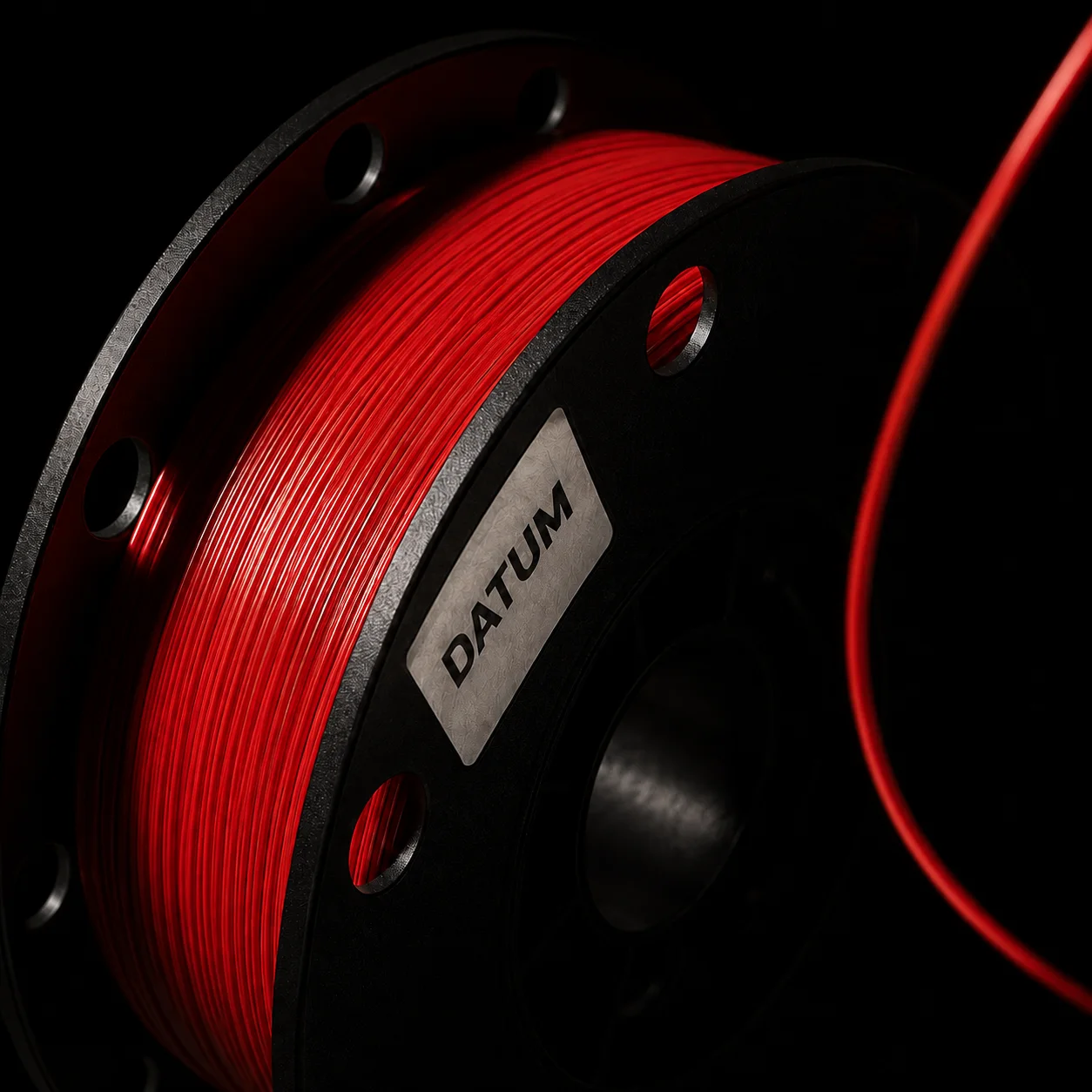 The same spool in Signal Red, shot under identical raking light so the two can be compared honestly.
